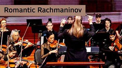 Students playing instruments with a conductor in the front