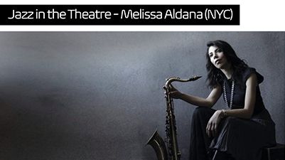 Women sitting on a chair with her Saxophone